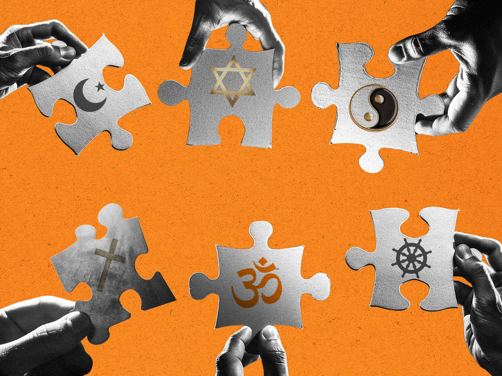 Hands hold puzzle pieces with religious symbols on an orange background, symbolizing unity and diversity.