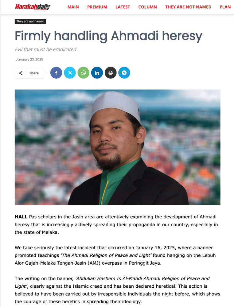 Un homme coiffé d’une calotte blanche apparaît sur une page d’actualité traitant de l’hérésie ahmadie à Malacca, datée du 23 janvier 2025. On y voit du texte et des icônes de réseaux sociaux.